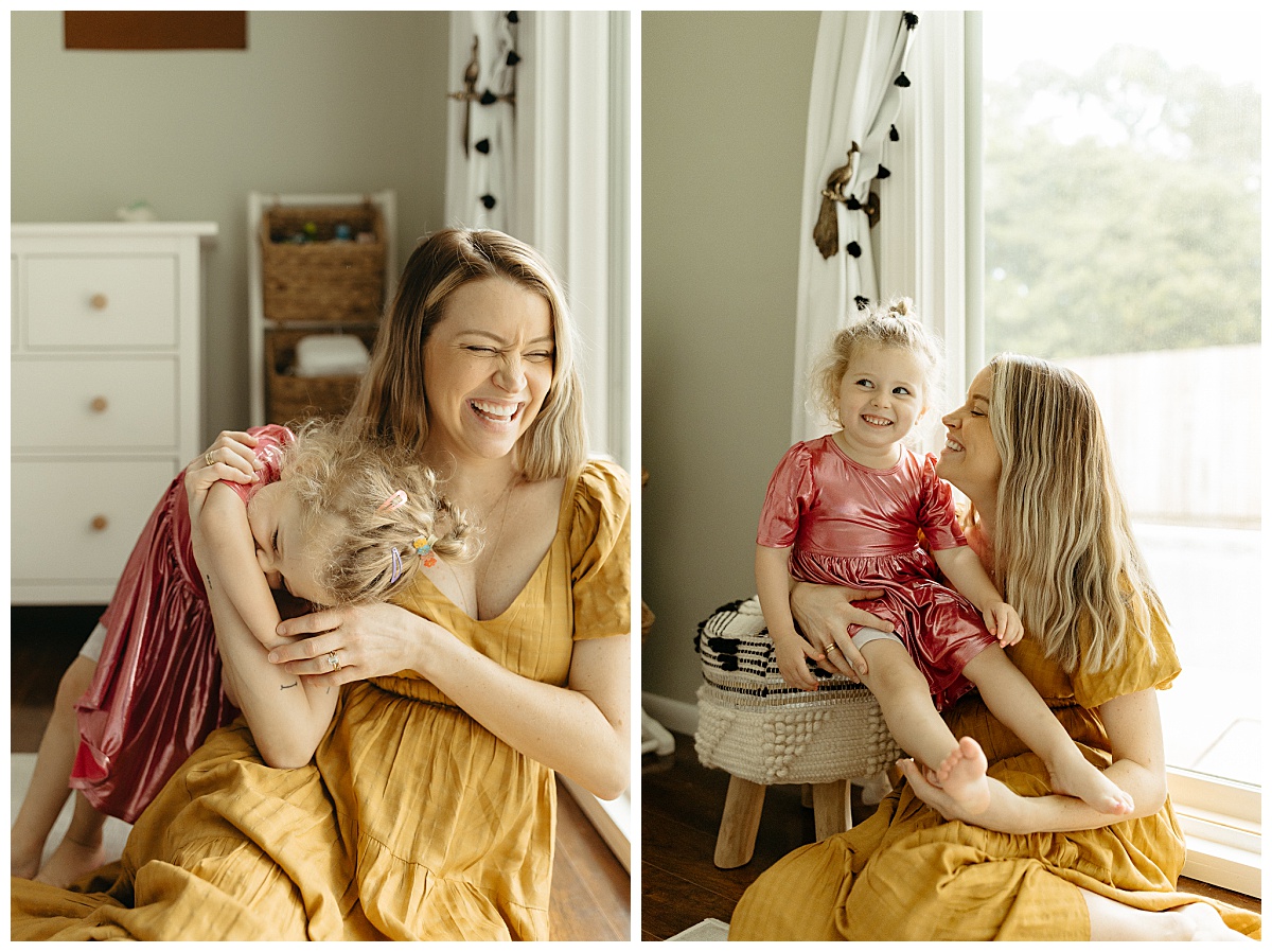 woman laughs as she hugs daughter during in-home newborn family session