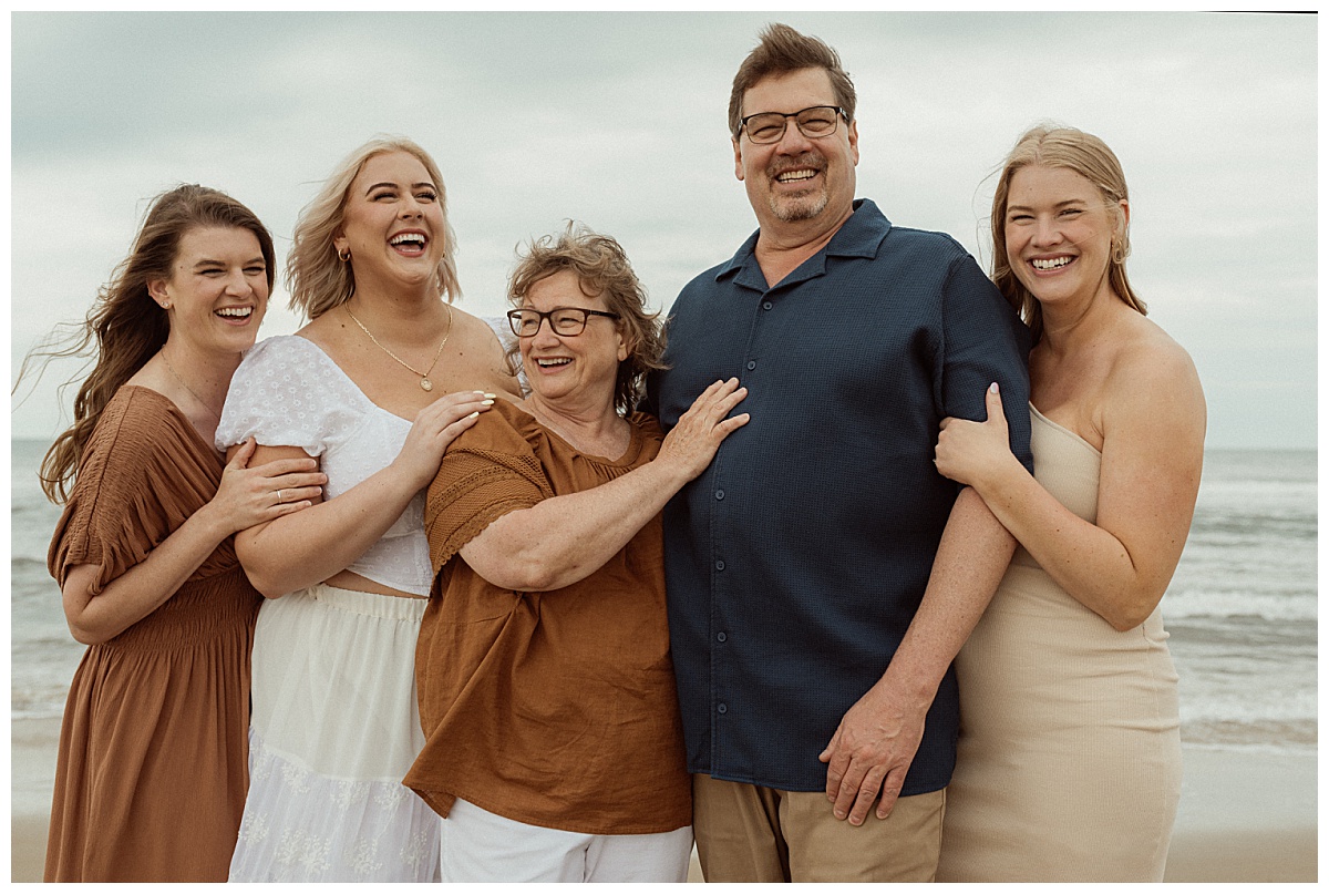 parents stand with their adult daughters at extended family session