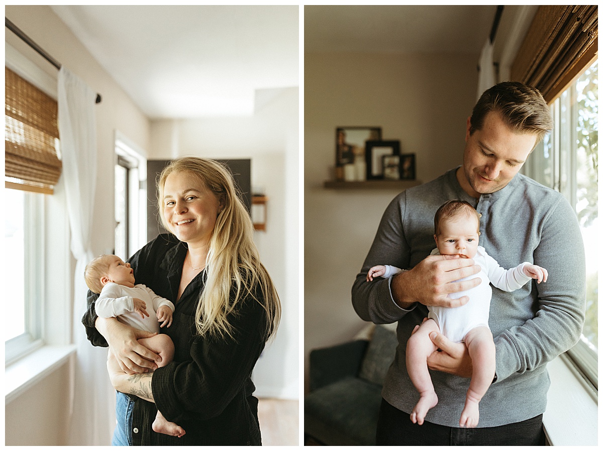 mother and father hold little one in front of window by Nikki Meer Photography