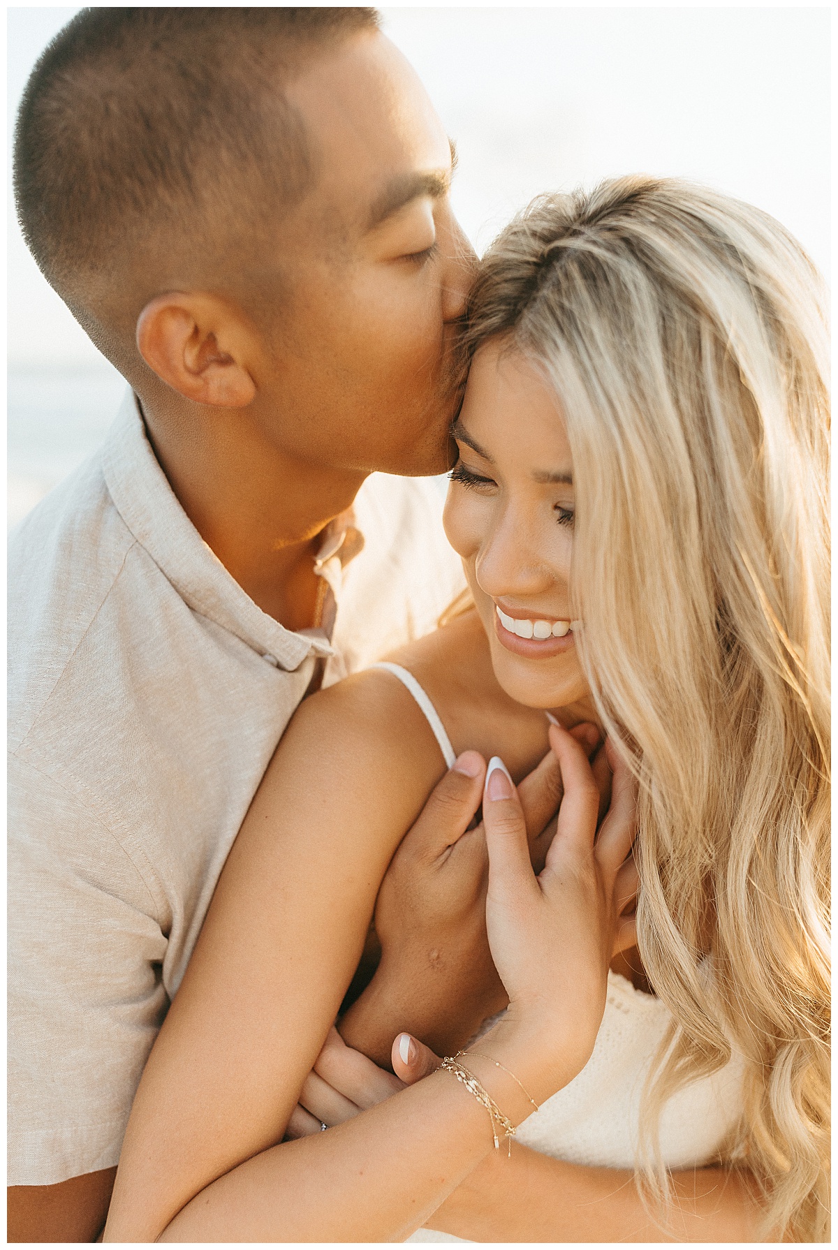 guy kisses girl on head by Virginia Beach photographer