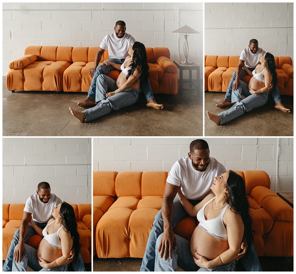couple sits on orange couch together by Nikki Meer Photography