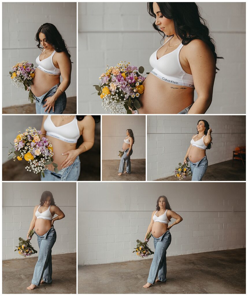pregnant woman in unbuttoned jeans and bra holds a colorful bouquet during Studio Muse Maternity Session