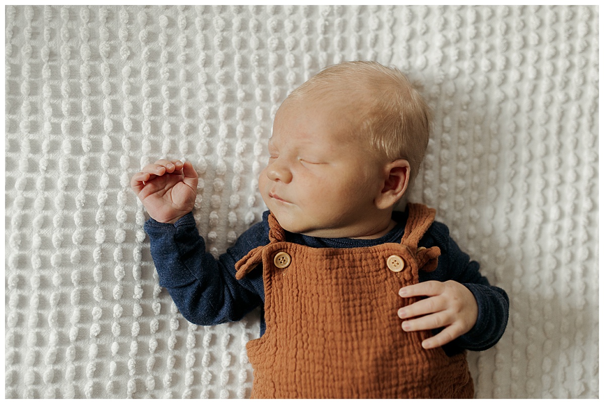 infant sleeps on white blanket during Heartwarming In-Home Newborn Session