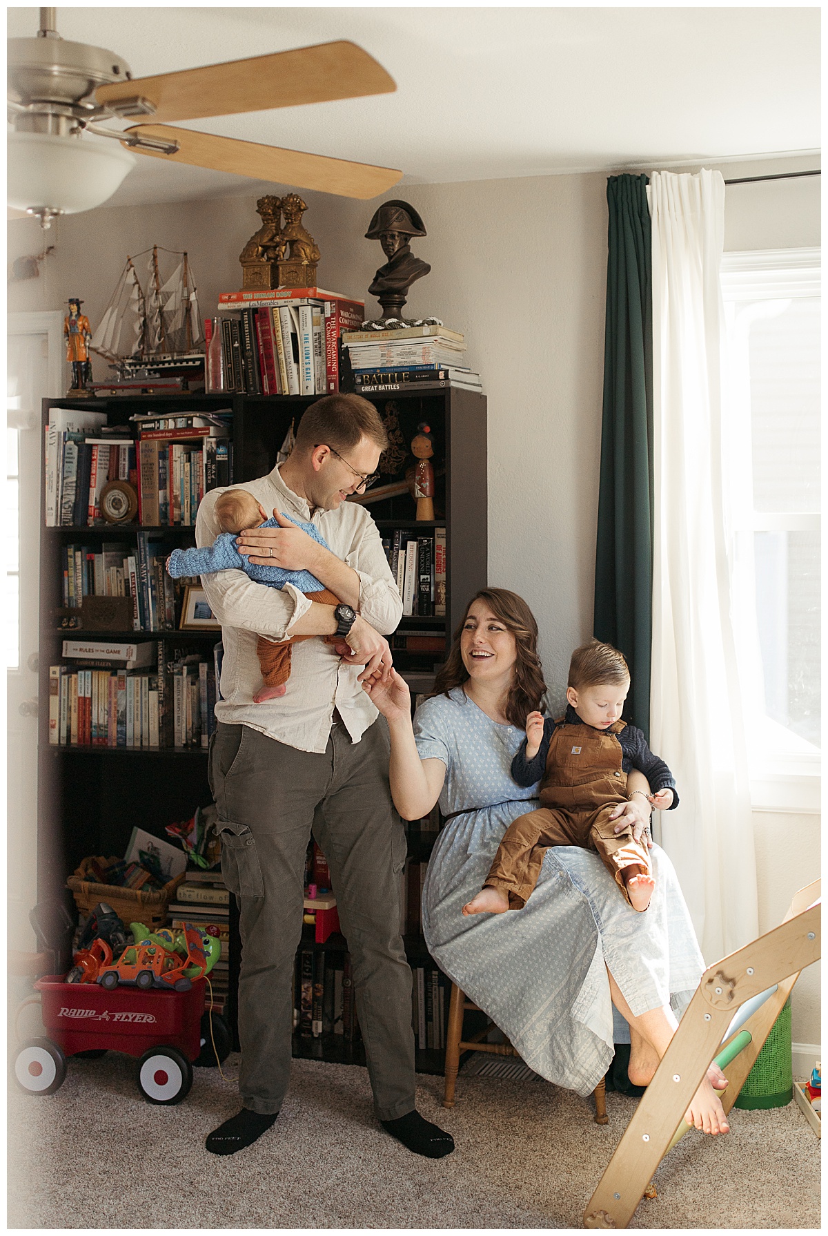 parents hold sons as they smile at each other by Nikki Meer Photography 