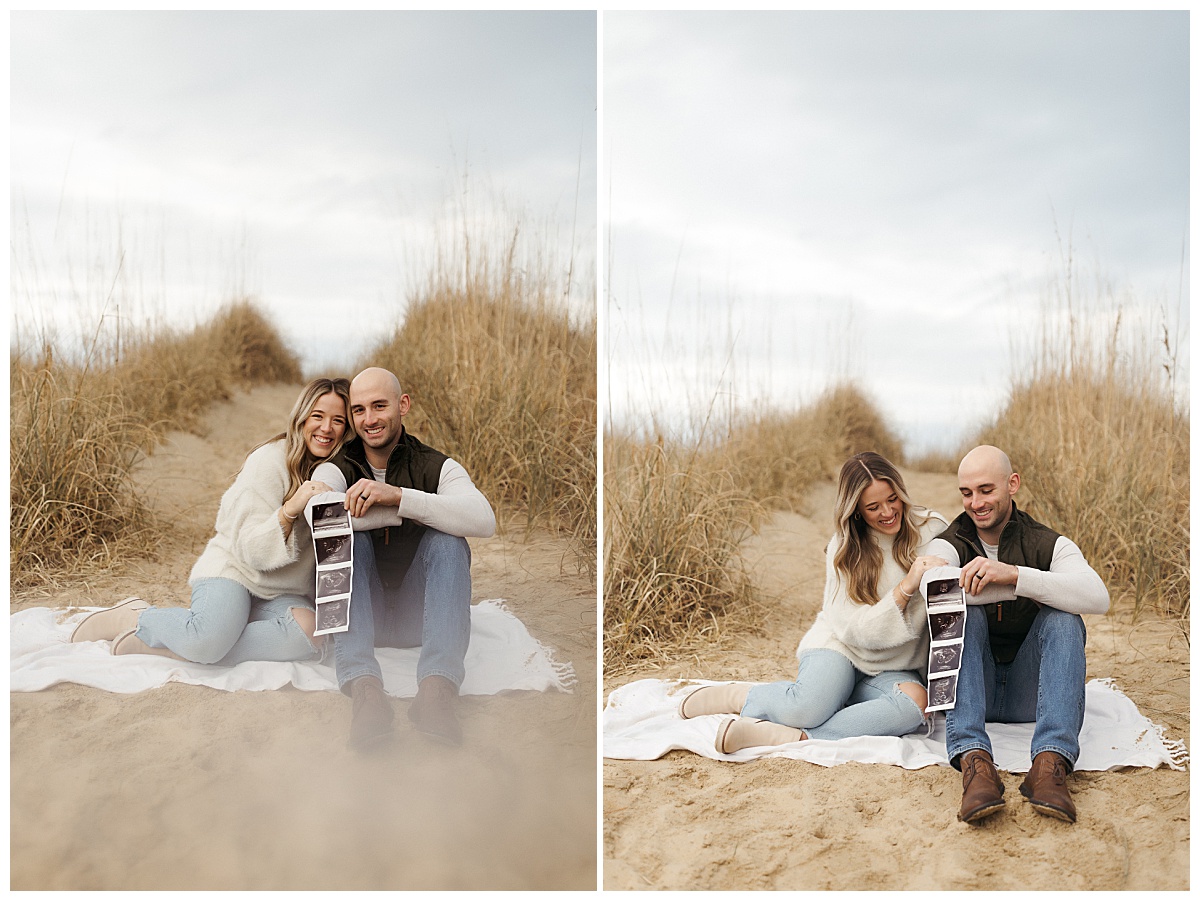 mom and dad to be snuggle up on a blanket at the beach by Nikki Meer Photography