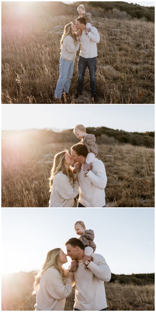 couple kisses while holding their child by Nikki Meer Photography