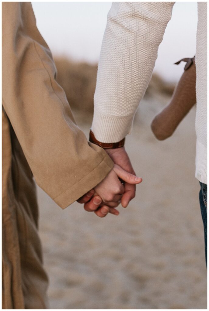 couple holds hands by Virginia Beach photographer